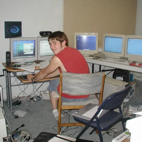 Teenage Doug at a desk surrounded by CRT monitors