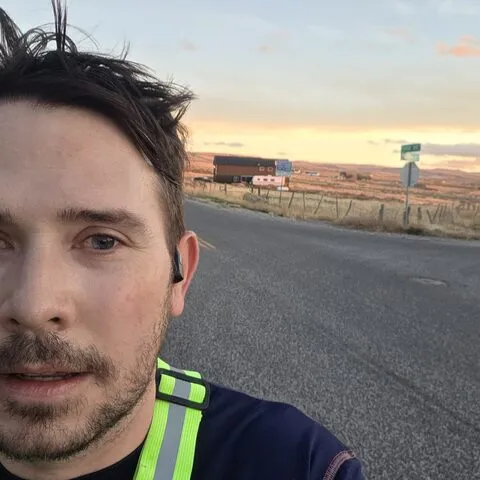 Doug on a run at sunset in a reflective vest